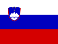 The image shows the national flag of Slovenia, featuring three horizontal stripes of white, blue, and red with a coat of arms displaying a mountain and three stars on the blue stripe.