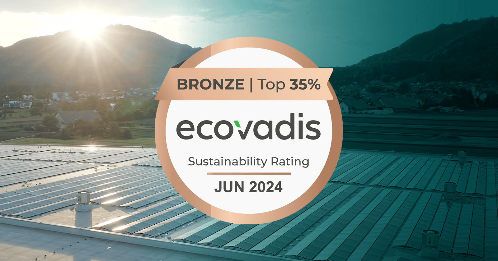 An EcoVadis Sustainability Rating badge with "Bronze | Top 35%" and "Jun 2024" text, set against a background image of a solar panel installation on a roof with mountains in the distance.