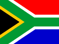 The image shows the national flag of South Africa, featuring horizontal bands of red and blue with green, yellow, black, and white Y-shaped pattern.